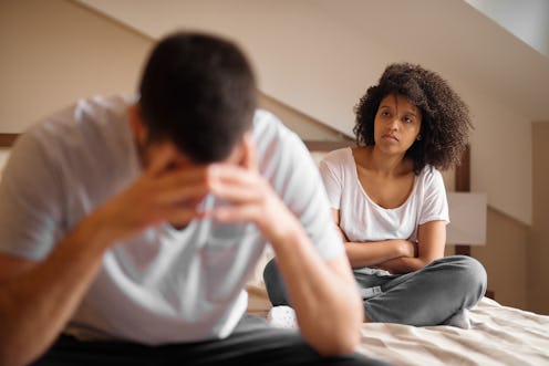 Couple breaking up after an argument in bedroom.