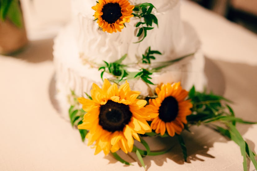 Wedding cake decorated with flowers of sunflower.