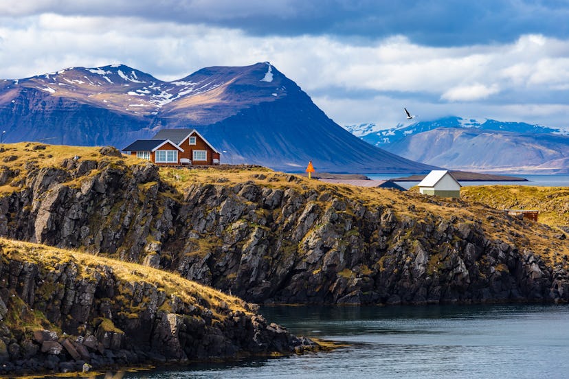 Typical Icelandic landscape with houses against mountains in small village of Stykkisholmur, Western...