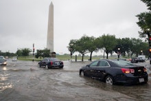 Heavy rainfall flooded the intersection of 15th Street and Constitution Ave., NW stalling cars in th...