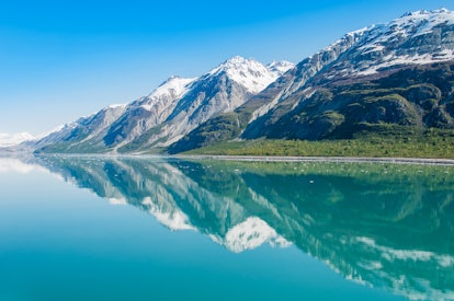 The beauty of North America | Alaska: Picturesque view of the mountains reflecting in still water of...