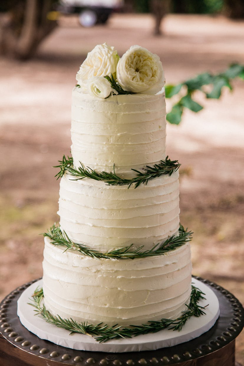 elegant and simple wedding cake with flowers on top