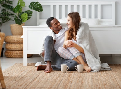 happy loving couple drinking cocoa on a winter morning in bed
