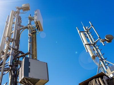 5G smart mobile telephone radio network antenna base station on the telecommunication mast radiating...