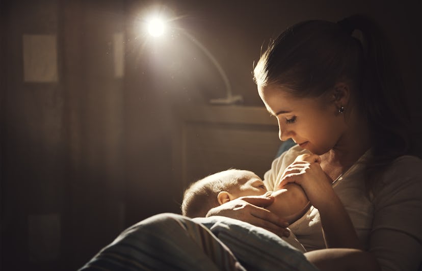 breast-feeding. mother breastfeeds the baby in the dark in bed
