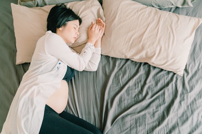 Young beautiful Asian pregnant woman  sleeping on bed  - selective focus point and vintage  style