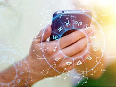 Astrology smartphone app concept, woman using mobile phone, close up of hands
    
    - Image