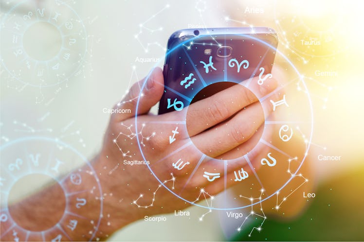 Astrology smartphone app concept, woman using mobile phone, close up of hands
    
    - Image