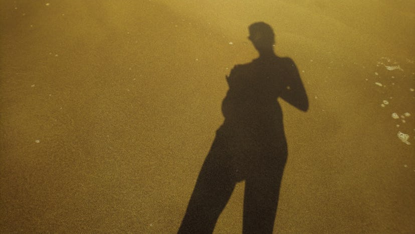 Woman shadow on a twilight background