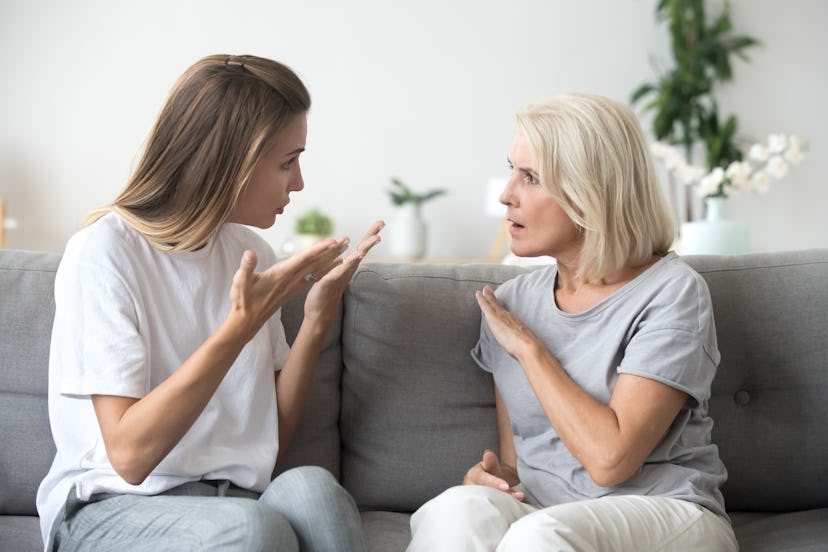 Angry young woman has disagreement with annoyed old mother in law, grown daughter arguing fighting q...