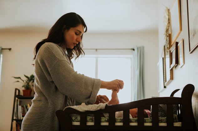 Mother changing a diaper on a newborn baby