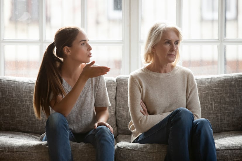 Annoyed grown up daughter expressing complaints to elderly mother annoyed females sit on couch, old ...