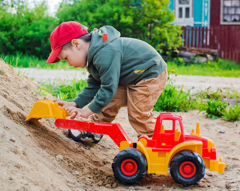 child playing in the sand excavator