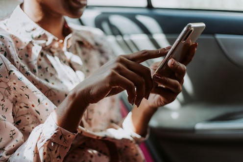 Woman using phone in a car