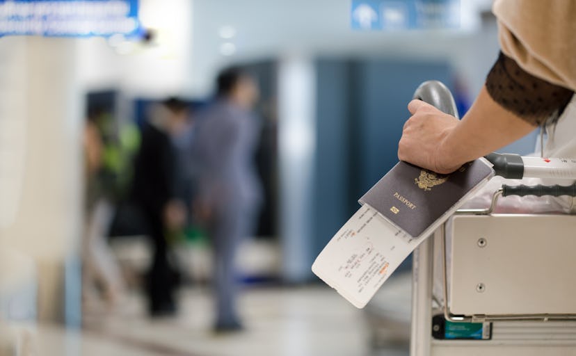 Closeup of girl  holding passports and boarding pass at airport