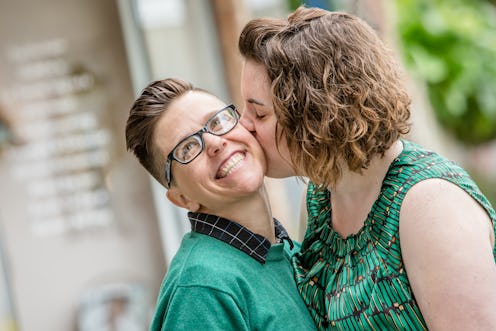 Close up of lesbian married couple kissing each other outdoors