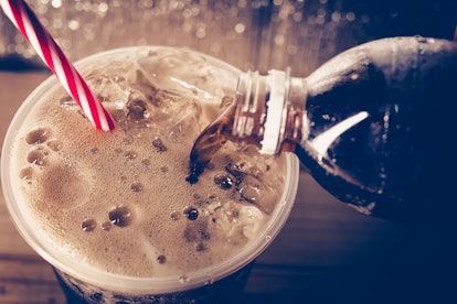 Refreshing Bubbly Soda Pop with Ice Cubes. Cold soda iced drink in a glasses - Selective focus, shal...