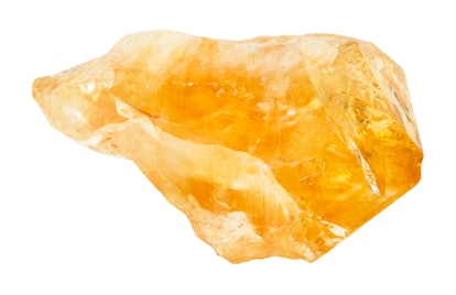 macro shooting of natural rock specimen - rough crystal of Citrine (yellow quartz) gemstone isolated...