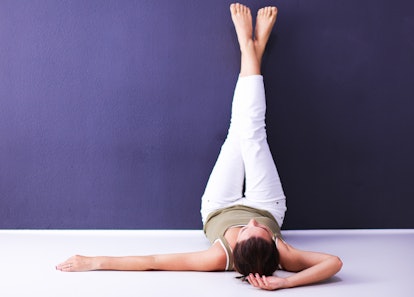 Young woman lying on the floor with legs up