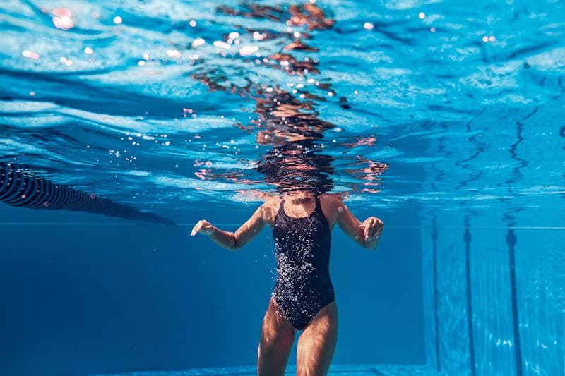 Underwater shot of a young woman swimming in the pool