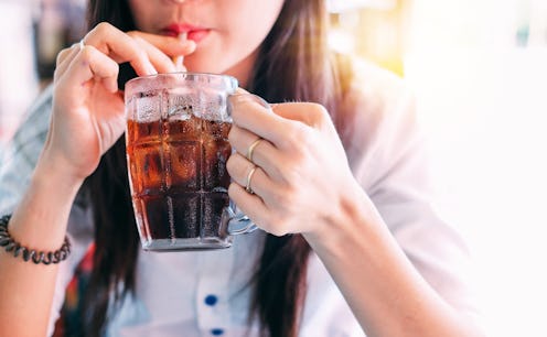 closeup woman drinking ice cola in the glass.food and beverage concept.
