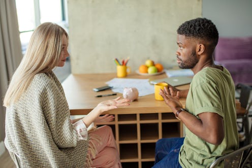 Caucasian blonde woman has some misunderstanding with her african hipster boyfriend, who is having s...