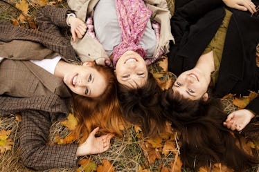 Three girls in the autumn park. Outdoor shot.