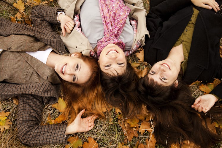Three girls in the autumn park. Outdoor shot.