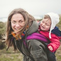 Mother laughing and having fun with your toddler outdoors
