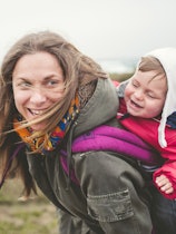 Mother laughing and having fun with your toddler outdoors