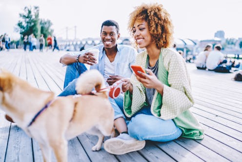 Portrait of african american hipster guy with coffee to go smiling at camera while spending sunny da...