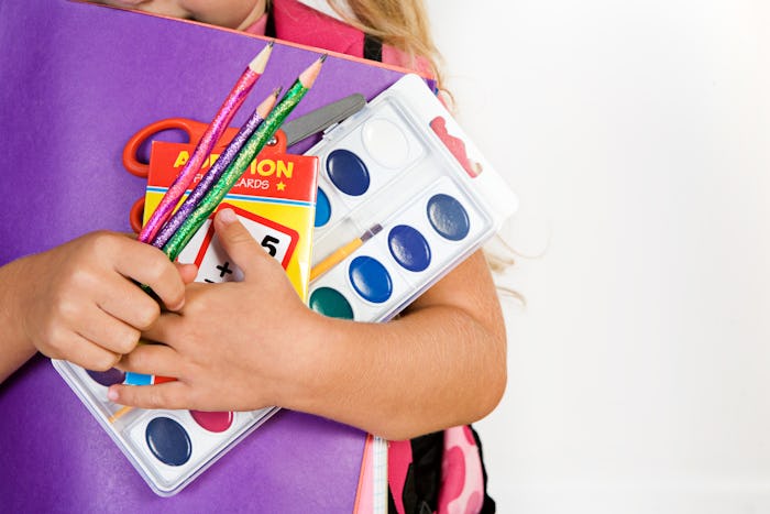 Education: Girl Holds Armful Of School Supplies