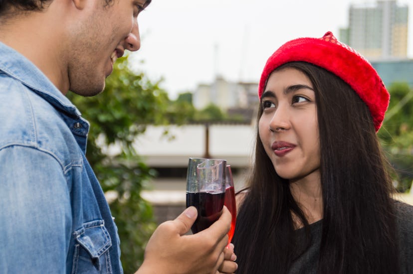 Young people holding glass talk in the party.