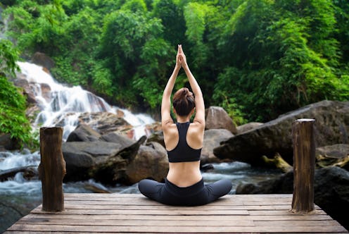 Healthy woman lifestyle balanced practicing meditate and zen energy yoga on the bridge in morning th...
