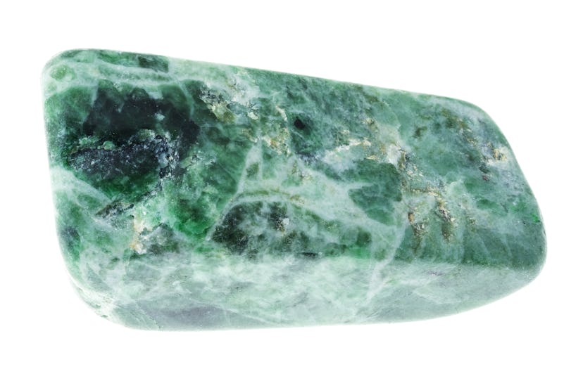 macro photography of natural mineral from geological collection - tumbled Jadeite (green jade) stone...