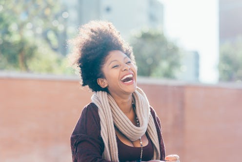 Portrait of young beautiful afro black woman looking over smiling - happiness, carefree, having fun ...