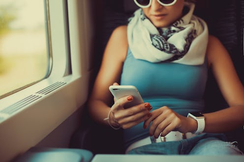 pretty woman in a cafe works on the phone, keep your smartphone in your hands, writes a letter, soci...