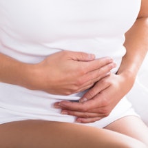 Close-up of a person holding their stomach. Some of the healthy habits you may have could actually i...