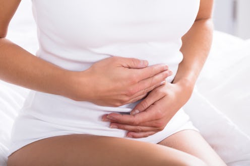 Close-up of a person holding their stomach. Some of the healthy habits you may have could actually i...