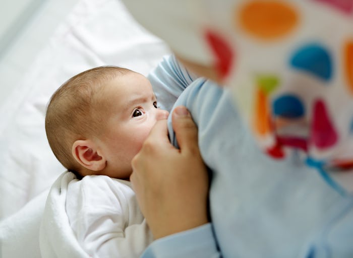 Arabic mother breast milk feeding her baby