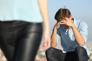 Sad man complaining outdoors after break up. Girlfriend leaving him