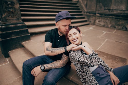 beautiful happy young couple in love sitting on stairs in Dresden