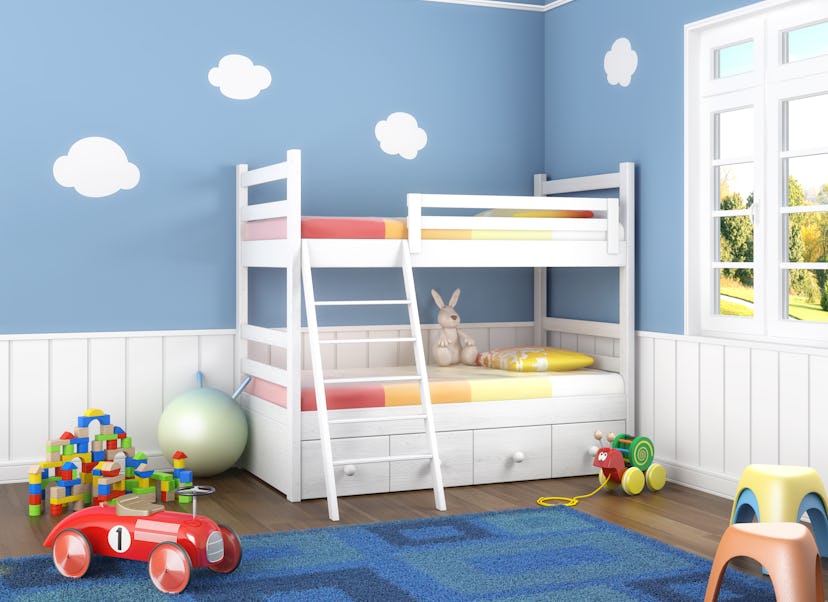 Children room in blue walls with bunk bed and lots of toys on the floor