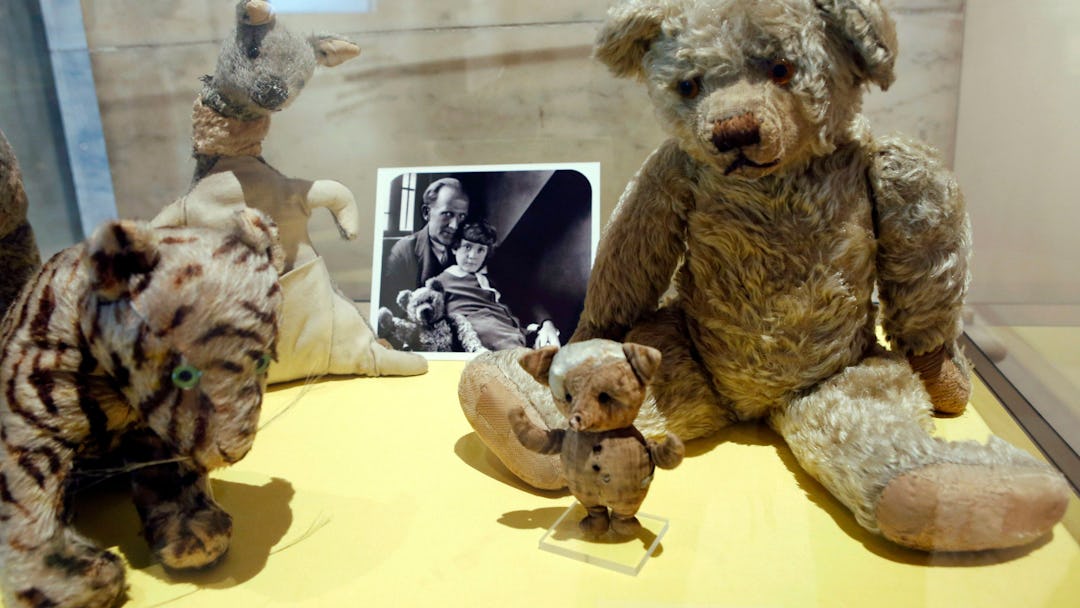 A. A. Milne, Christopher Robin A photograph of author A. A. Milne with his son Christopher Robin is ...
