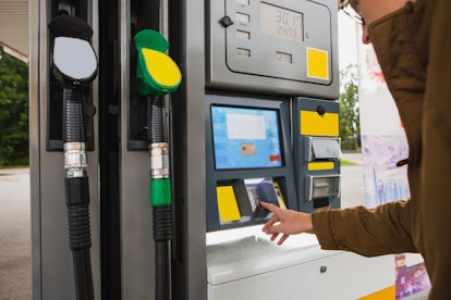 Self-service filling station. The man pays for fuel with a credit card