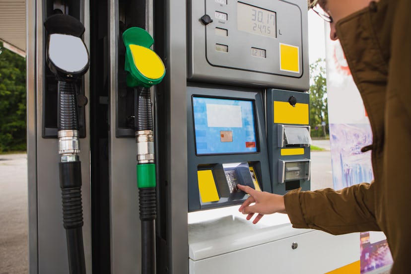 Self-service filling station. The man pays for fuel with a credit card