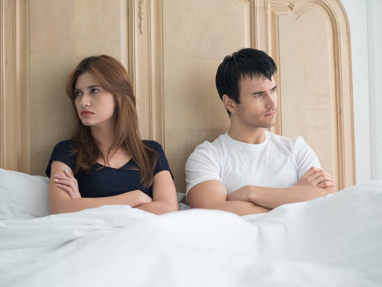 Upset young couple having problems in bedroom. Unhappy, upset, negative emotions concept.