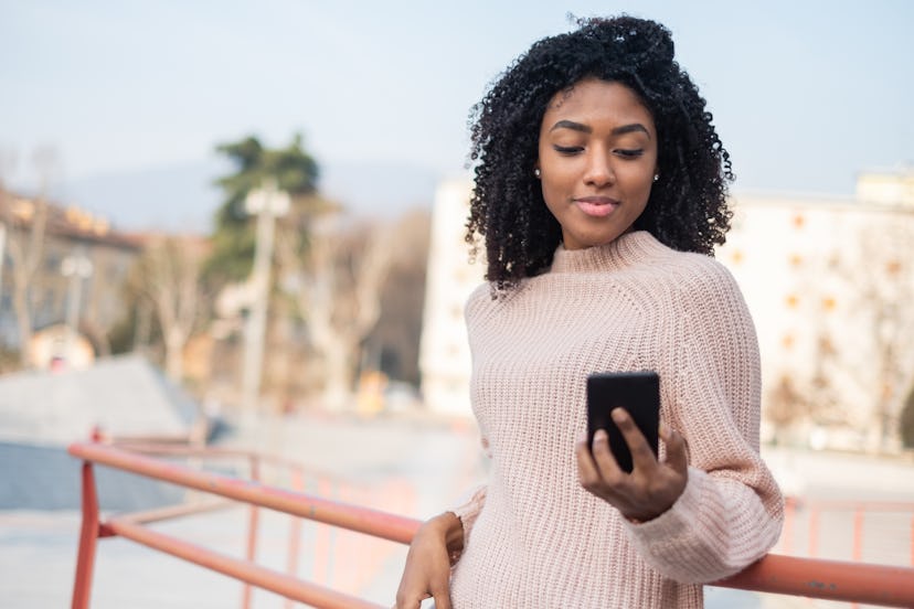 Black afro-american woman using mobile phone