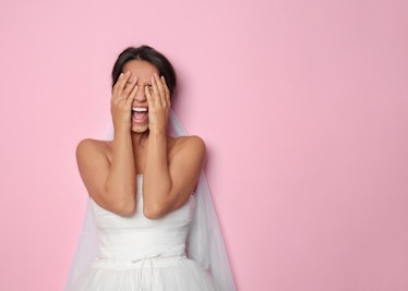 Screaming young bride on color background