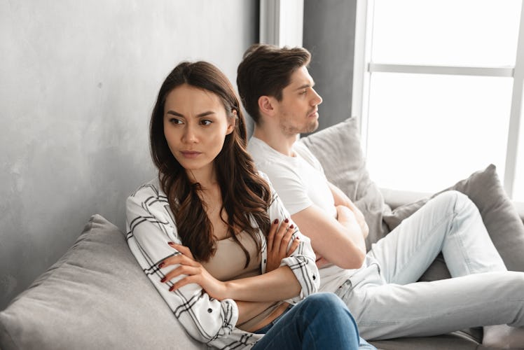 Photo of resentful guy and girl acting like arguing couple and not speaking to each other, while sit...